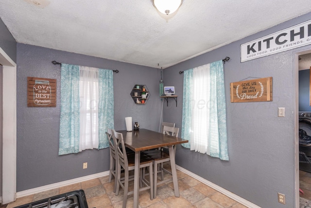 210 Oak Ave, Dumas, TX 79029 - dining space featuring plenty of natural light, a textured ceiling, and stone finish floors