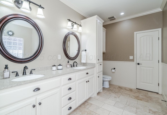 7601 Continental Pkwy, Amarillo, TX 79119 - bathroom featuring double vanity, crown molding, and wainscoting
