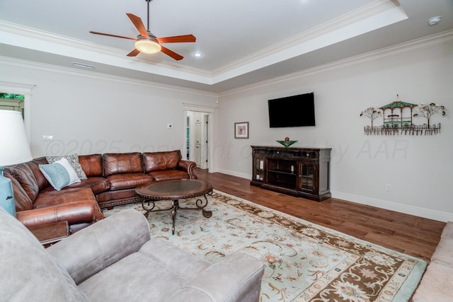 7601 Continental Pkwy, Amarillo, TX 79119 - living area featuring a tray ceiling, ceiling fan, ornamental molding, and wood finished floors