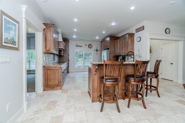 7601 Continental Pkwy, Amarillo, TX 79119 - kitchen with freestanding refrigerator, decorative backsplash, light stone countertops, a peninsula, and a kitchen breakfast bar