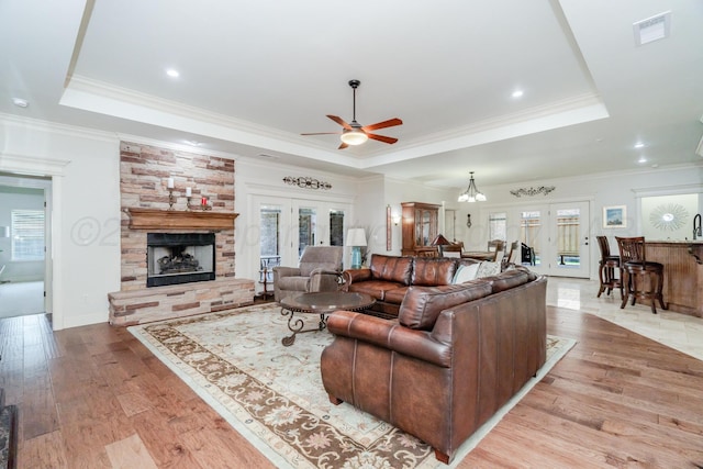 7601 Continental Pkwy, Amarillo, TX 79119 - living room featuring a tray ceiling, a ceiling fan, healthy amount of natural light, french doors, and crown molding