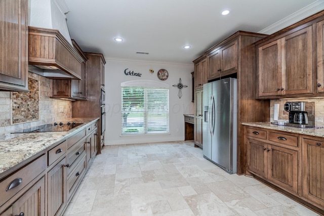 7601 Continental Pkwy, Amarillo, TX 79119 - kitchen with stainless steel fridge with ice dispenser, premium range hood, black electric cooktop, light stone countertops, and backsplash