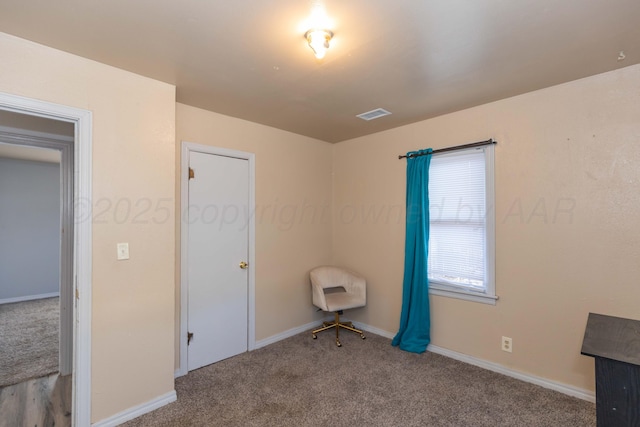 unfurnished bedroom featuring baseboards, carpet flooring, and visible vents