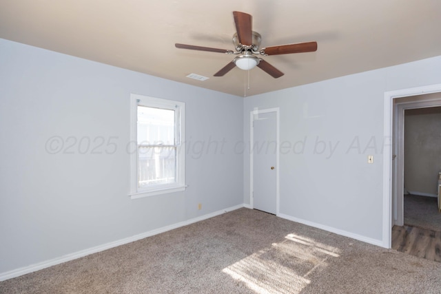unfurnished bedroom featuring carpet floors, a closet, baseboards, and ceiling fan