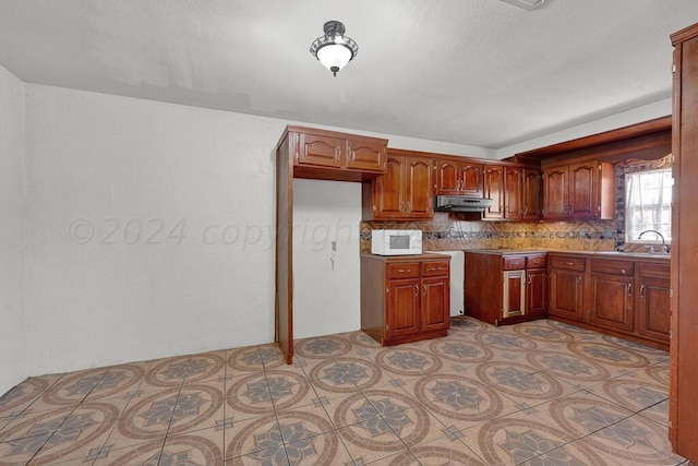 kitchen with tasteful backsplash, sink, and light tile patterned floors