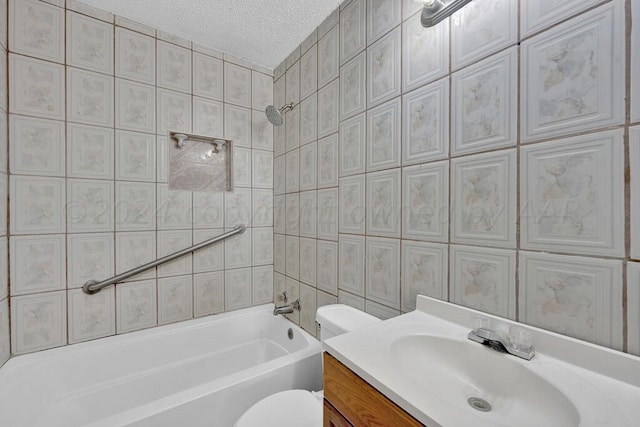 full bathroom with toilet, tiled shower / bath combo, vanity, and a textured ceiling