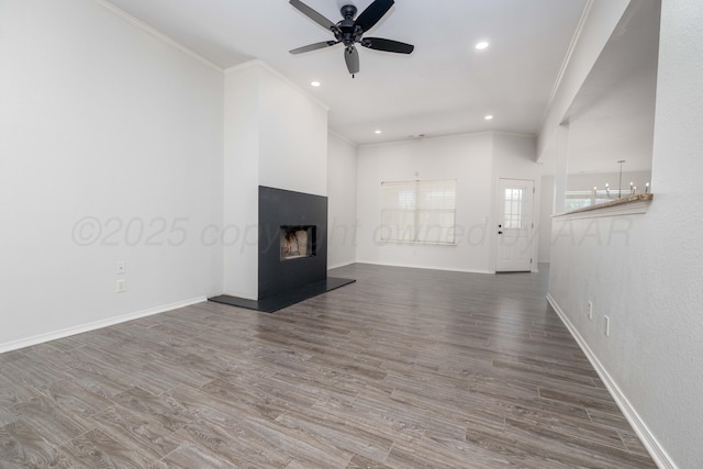 7703 Fresno Dr, Amarillo, TX 79118 - unfurnished living room with crown molding, ceiling fan, a fireplace with raised hearth, baseboards, and wood finished floors