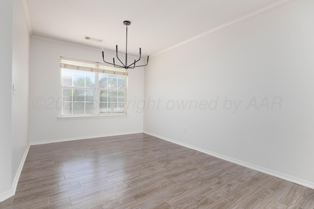 7703 Fresno Dr, Amarillo, TX 79118 - unfurnished room featuring a chandelier, wood finished floors, ornamental molding, and baseboards