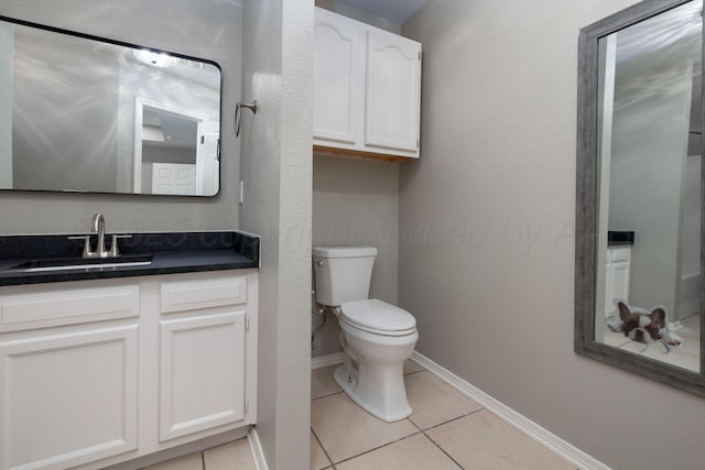 7703 Fresno Dr, Amarillo, TX 79118 - half bathroom featuring toilet, tile patterned floors, baseboards, and vanity