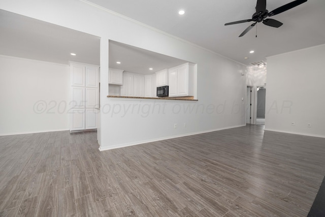7703 Fresno Dr, Amarillo, TX 79118 - unfurnished living room featuring ornamental molding, a ceiling fan, wood finished floors, recessed lighting, and baseboards
