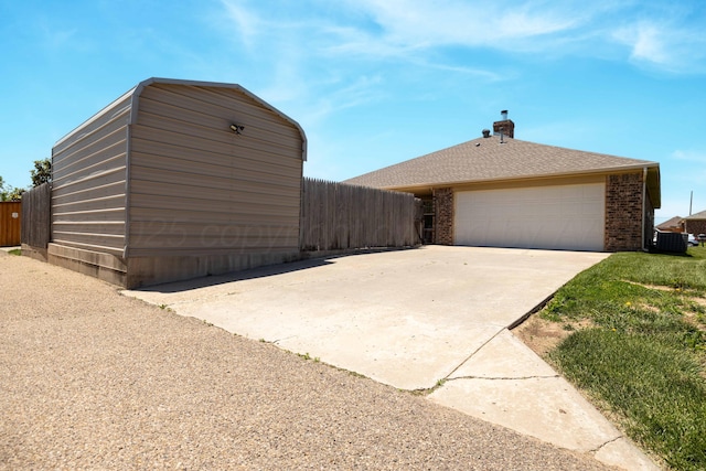 7703 Fresno Dr, Amarillo, TX 79118 - view of property exterior featuring fence, brick siding, a garage, and concrete driveway