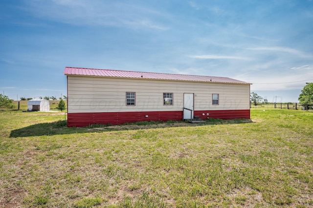 rear view of property with a yard