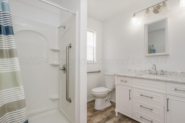 bathroom featuring a shower with shower curtain, wood-type flooring, vanity, and toilet