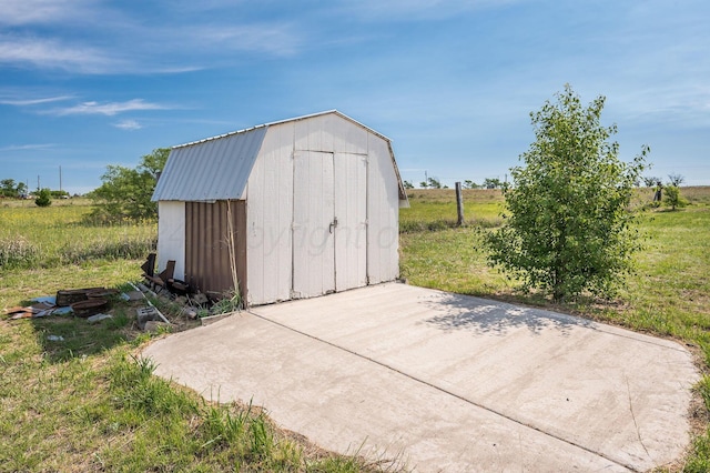 view of outdoor structure with a rural view