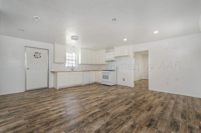 kitchen with decorative backsplash, white appliances, sink, white cabinets, and dark hardwood / wood-style floors