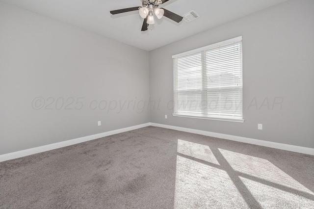 carpeted spare room featuring ceiling fan