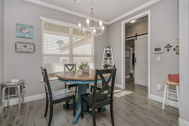 dining area with crown molding, a barn door, and an inviting chandelier