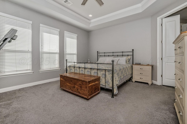 carpeted bedroom featuring a raised ceiling, ornamental molding, and ceiling fan