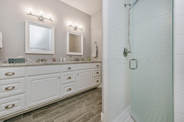 bathroom with an enclosed shower and vanity