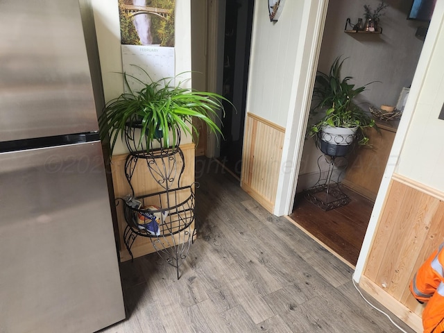 interior details with wood finished floors and freestanding refrigerator