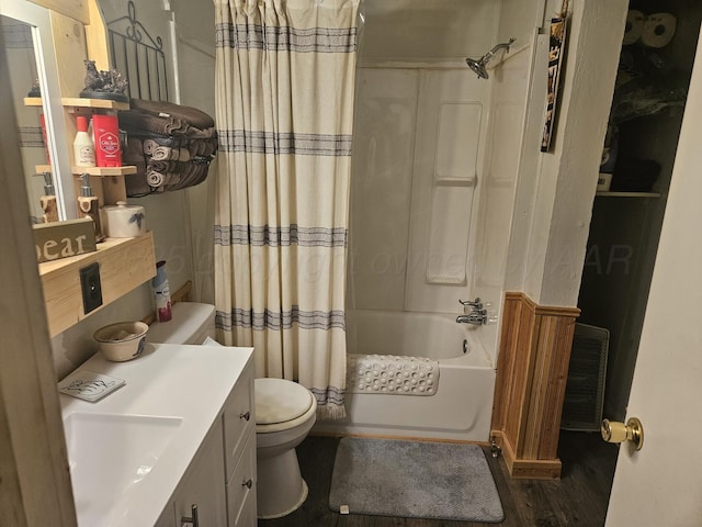bathroom featuring wood finished floors, shower / bath combination with curtain, toilet, and vanity