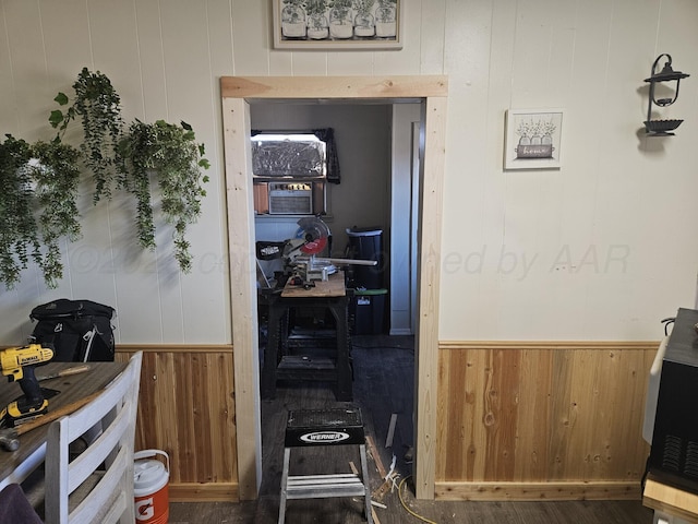 interior space featuring wainscoting, wood finished floors, and wooden walls
