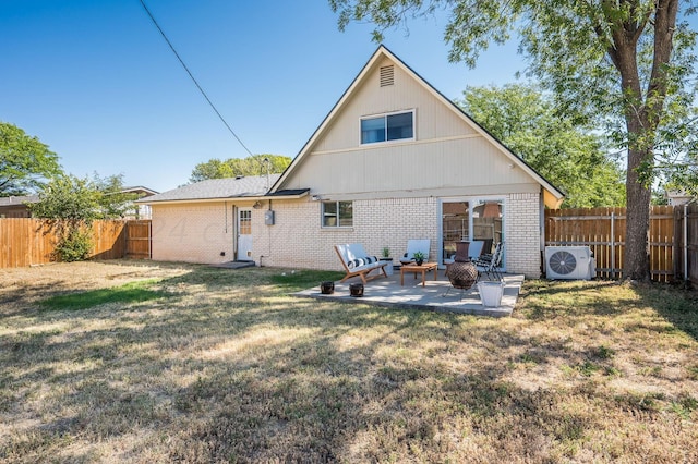 back of house with ac unit, a yard, brick siding, and a fenced backyard