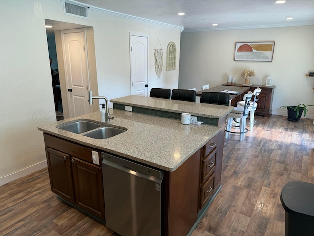 kitchen with stainless steel dishwasher, crown molding, a sink, visible vents, and an island with sink