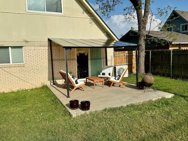 back of property with brick siding, fence, and a yard