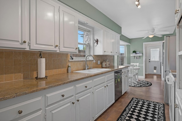 3101 SW 28th Ave, Amarillo, TX 79109 - kitchen featuring white cabinets, dishwasher, backsplash, and a sink