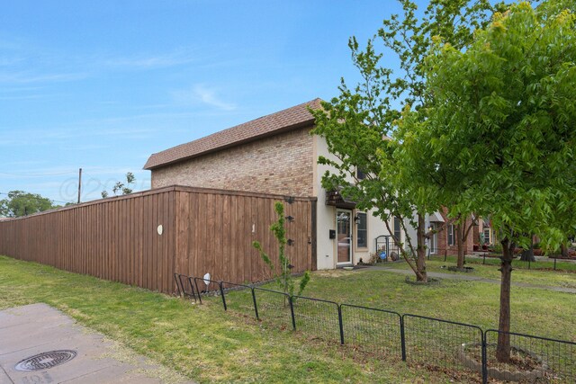 3101 SW 28th Ave, Amarillo, TX 79109 - view of side of home featuring brick siding, fence, and a lawn