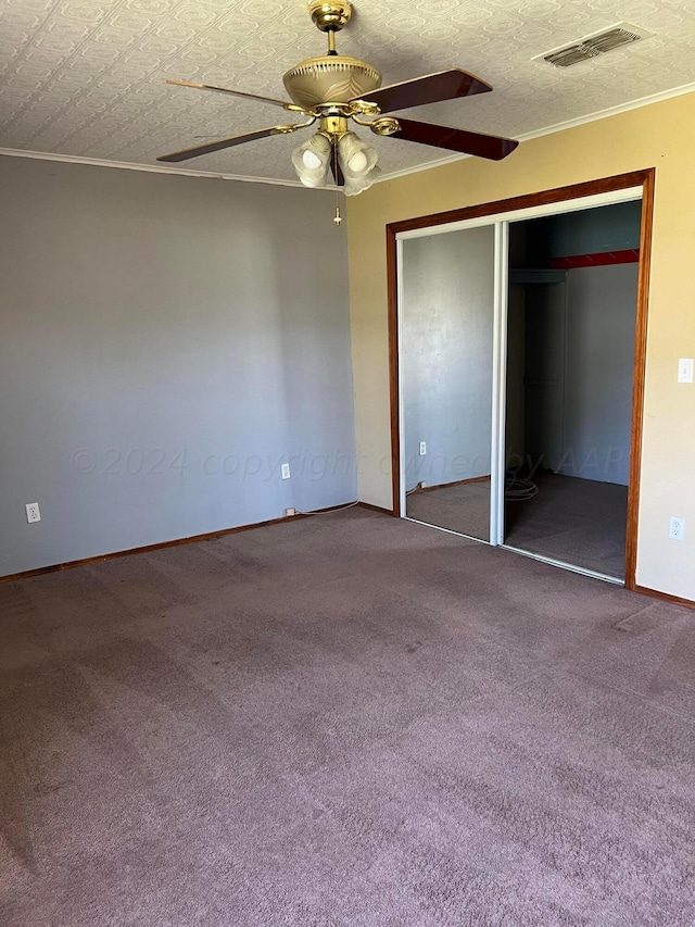 unfurnished bedroom featuring a textured ceiling, carpet flooring, ceiling fan, and a closet