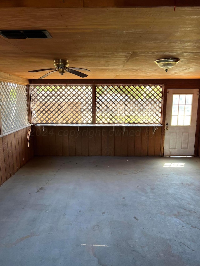 unfurnished sunroom featuring ceiling fan and visible vents