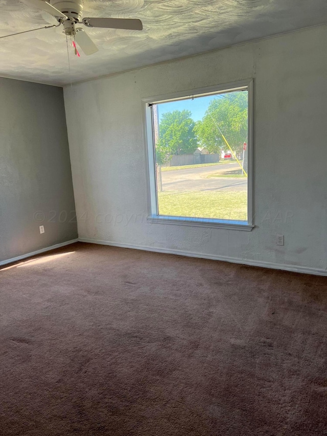 unfurnished room with carpet and ceiling fan