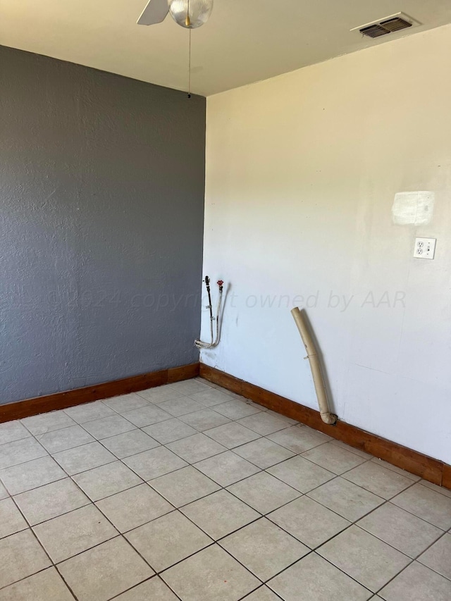 unfurnished room featuring baseboards, visible vents, and a ceiling fan