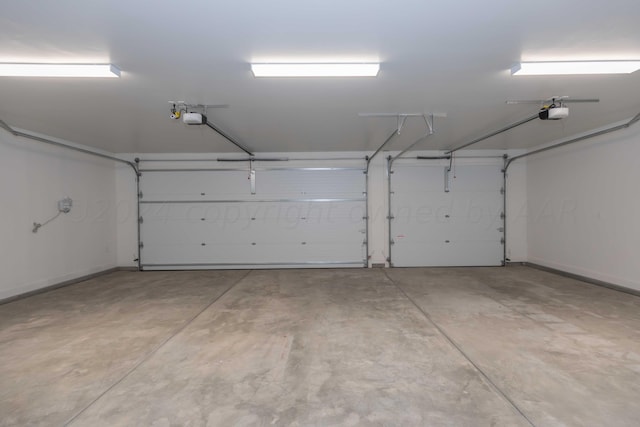9504 Stonecrest Dr, Amarillo, TX 79118 - garage with a garage door opener and baseboards