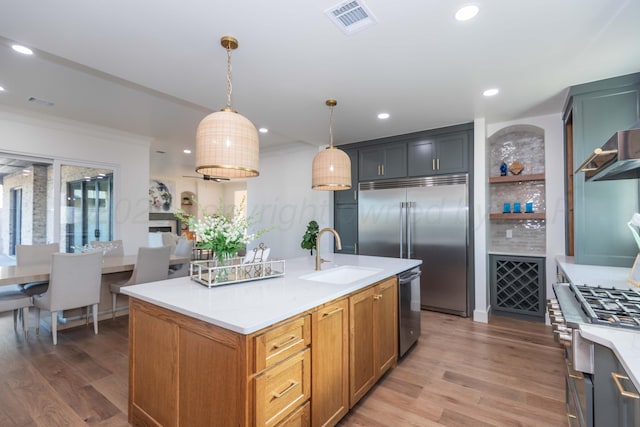 9504 Stonecrest Dr, Amarillo, TX 79118 - kitchen featuring a sink, appliances with stainless steel finishes, light wood finished floors, light countertops, and recessed lighting