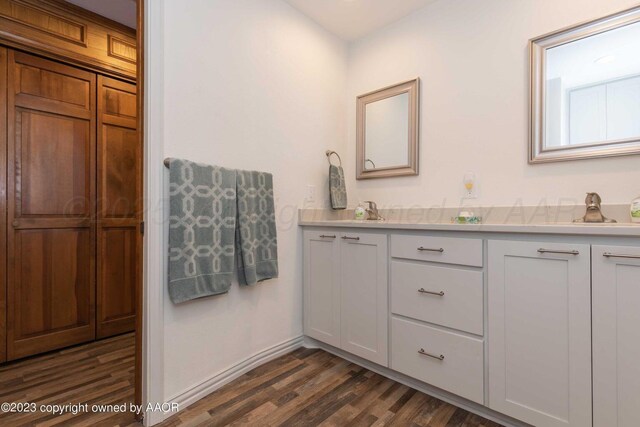 6810 Montague Dr, Amarillo, TX 79109 - bathroom featuring double vanity and wood finished floors