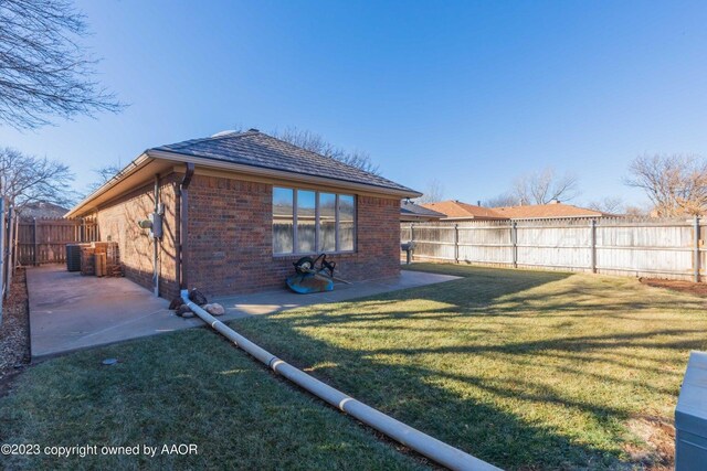 6810 Montague Dr, Amarillo, TX 79109 - back of house featuring brick siding, a fenced backyard, and a patio