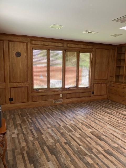 6810 Montague Dr, Amarillo, TX 79109 - unfurnished living room with healthy amount of natural light and dark wood-type flooring