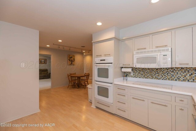 6810 Montague Dr, Amarillo, TX 79109 - kitchen with white appliances, backsplash, light countertops, light wood finished floors, and recessed lighting