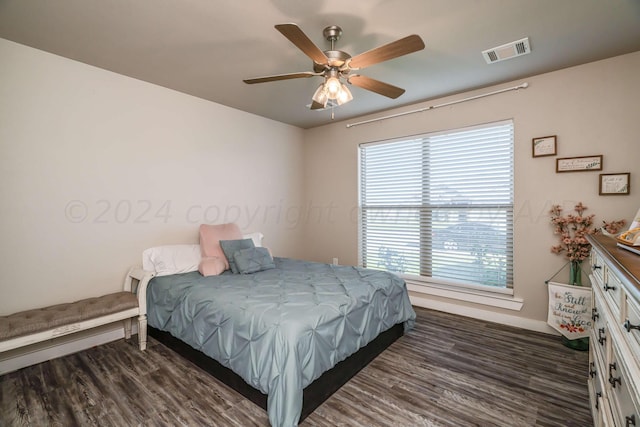 bedroom with ceiling fan and dark hardwood / wood-style flooring