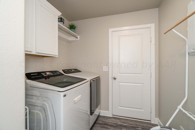 washroom with cabinets, washer and clothes dryer, and dark hardwood / wood-style flooring