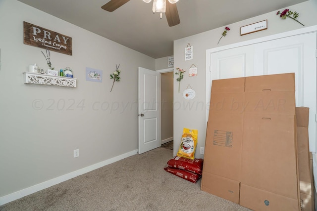 rec room with carpet and ceiling fan