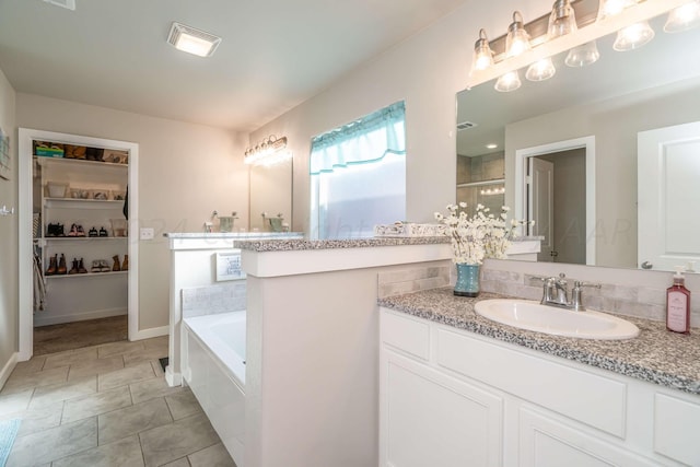 bathroom with vanity, plus walk in shower, and tile patterned flooring