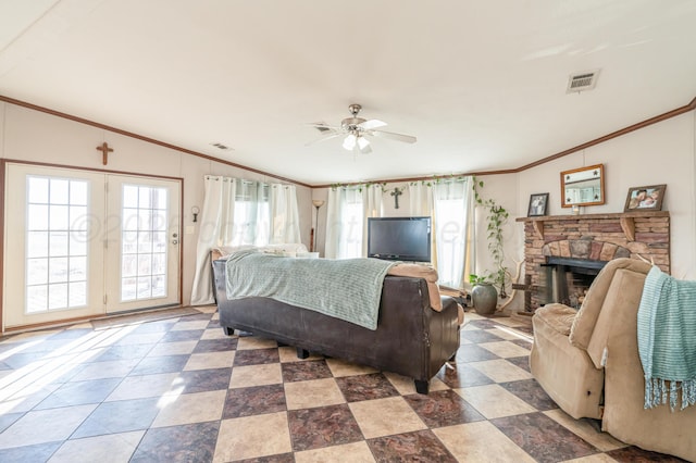 bedroom featuring multiple windows, crown molding, a stone fireplace, and ceiling fan