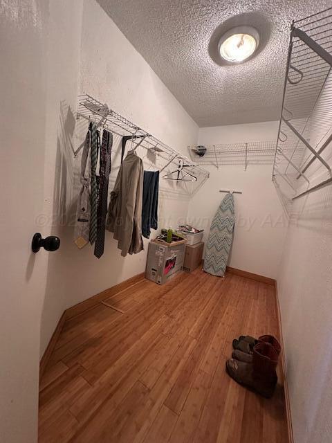 spacious closet with wood finished floors