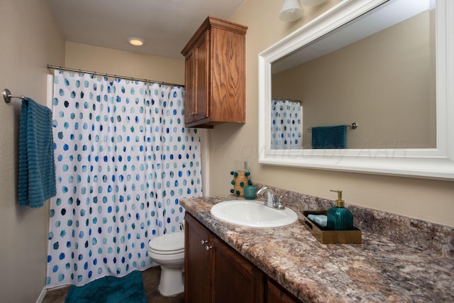 full bathroom with vanity, tile patterned floors, toilet, and curtained shower