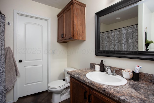 bathroom featuring vanity and toilet