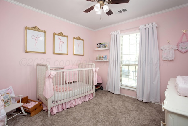 carpeted bedroom with visible vents, a crib, ornamental molding, and multiple windows